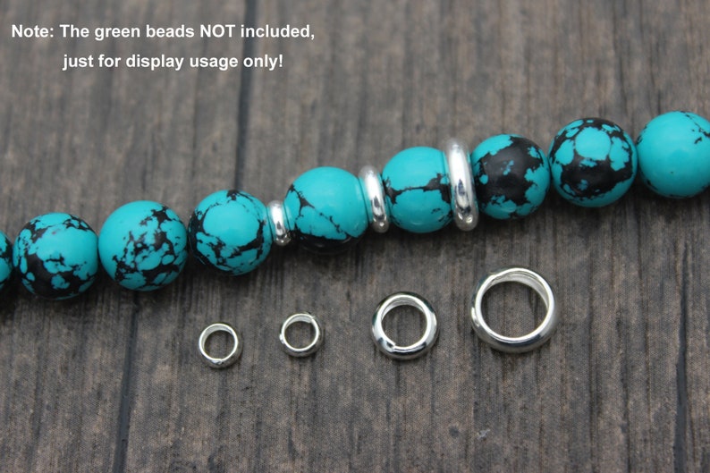 May include: Five silver jump rings of different sizes, with a turquoise and black bead bracelet in the background. Note: The green beads NOT included, just for display usage only!