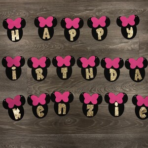 May include: Black and pink felt banner with gold glitter letters spelling "Happy Birthday Kenzie".