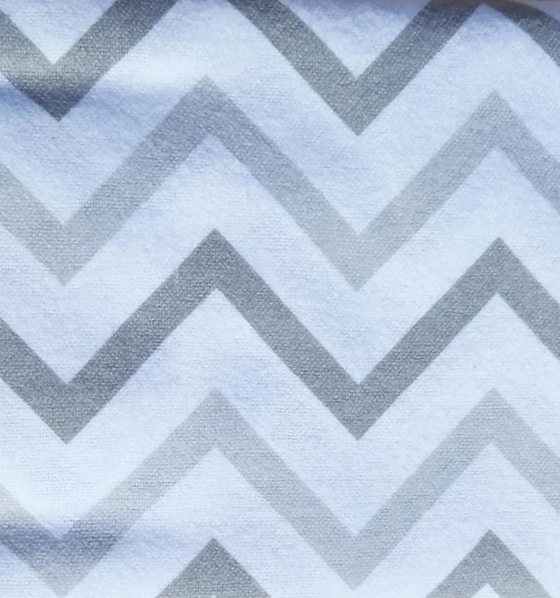 May include: White fabric with a chevron pattern in grey. The fabric has a soft, textured feel.