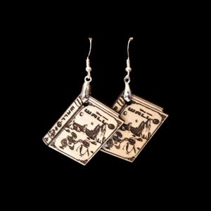 May include: A pair of dangle earrings featuring rectangular wooden charms with a laser-engraved illustration of the movie Wall-E. The design includes the text Wall-E, the robot character, and a landscape scene. The charms hang from silver-toned metal hooks.