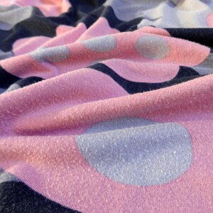 May include: Pink and gray fabric with a polka dot pattern. The fabric is soft and textured.