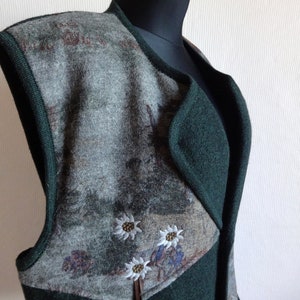 Puede incluir: Un chaleco sin mangas con un dise&ntilde;o estampado en verde y gris. El chaleco tiene cuello y cierre de cremallera. El estampado incluye flores blancas bordadas.