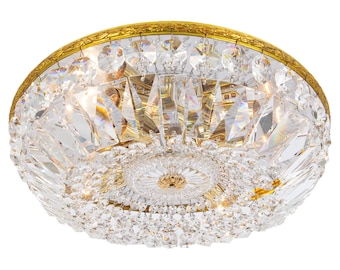 May include: A gold-toned flush mount ceiling light fixture with a crystal design. The fixture has a round shape and features a central crystal cluster surrounded by smaller crystals.