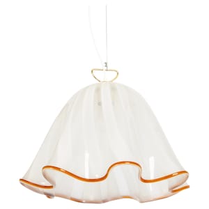 May include: White glass pendant light with a ruffled edge and a gold metal top. The light has a brown trim around the edge.