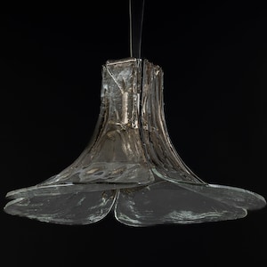 May include: A clear glass pendant light fixture with a bell-shaped top and a three-petal flower-shaped bottom.