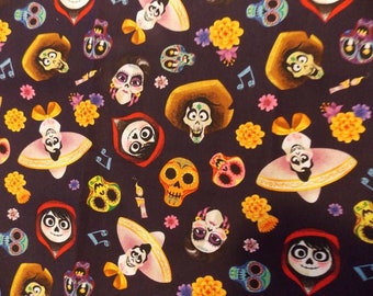May include: A dark blue fabric featuring a repeating pattern of colorful skulls, musical notes, and floral accents. The skulls are depicted in various styles, some wearing hats and sombreros, others with floral decorations. The design has a festive, Day of the Dead theme.