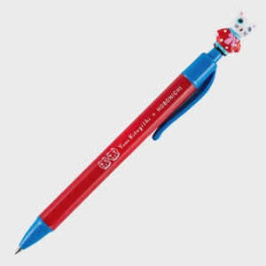 May include: A red and blue pen featuring a cat-shaped topper. The pen's barrel is printed with "Yumi Kitagishi x Hobonichi". The cat topper is white with blue eyes and a red bow.