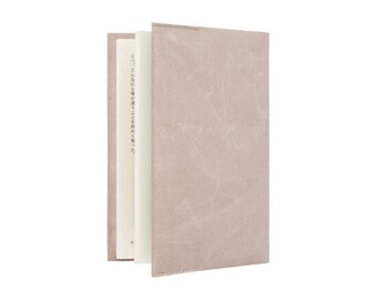May include: A light brown book cover with a textured surface. The cover has a white spine with Japanese text.