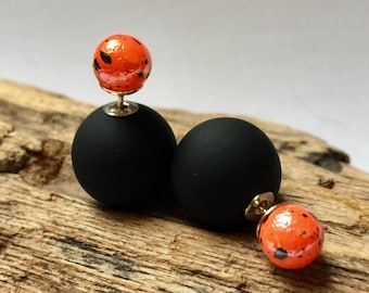 Elegant pair of matte black and iridescent orange double sided earrings, front and back French style studs