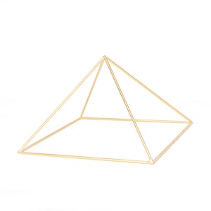 May include: A gold metal pyramid shaped frame. The frame is made of thin wire and is open on all sides.