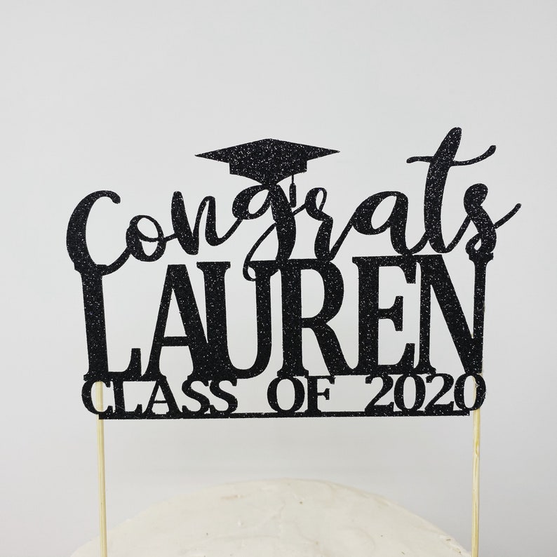 May include: Black glitter graduation cake topper with the text "Congrats Lauren Class of 2020".