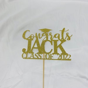 May include: Gold glitter cake topper with the text "Congrats Jack Class of 2022".