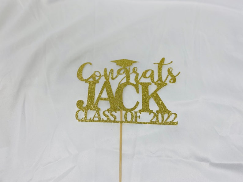 May include: Gold glitter cake topper with the text "Congrats Jack Class of 2022".