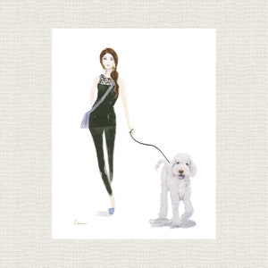 May include: Watercolour illustration of a woman walking a white dog. The woman wears a black outfit with a purple bag and gold earrings. The dog is on a lead. The artwork is signed "Cori".