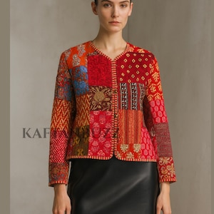 May include: A patchwork jacket with a V-neck and long sleeves. The jacket features a variety of patterns and colors, including red, orange, blue, and gold. The word "KAF" is printed on the left side of the jacket.