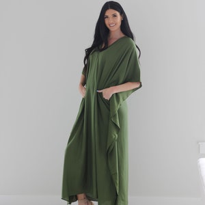 May include: A long, flowing green maxi dress with a V-neck and short sleeves. The dress has a relaxed fit and is made of a soft, comfortable fabric.