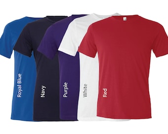 May include: Five plain t-shirts in different colors: royal blue, navy, purple, white, and red. The shirts are laid out in a row, with the colors arranged from left to right.