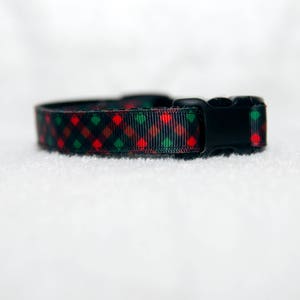 May include: A black and green plaid dog collar with a black plastic buckle.