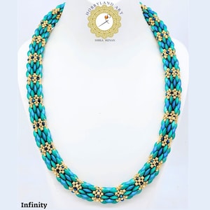 May include: A turquoise and gold beaded necklace with a repeating pattern of flowers. The necklace is on a white mannequin bust. The text "Infinity" is below the necklace.