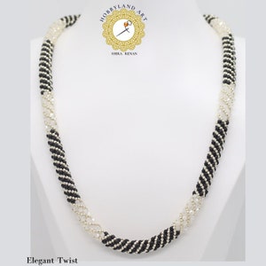 May include: A black and white beaded necklace with a twisted design. The necklace is made with small, round beads and has a silver finish. The necklace is called "Elegant Twist".