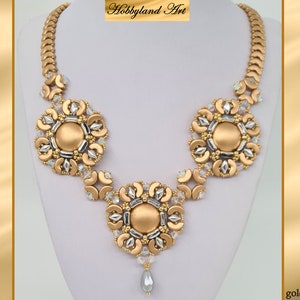 May include: A gold and silver beaded necklace with three large, circular, gold-toned bead clusters. The necklace has a delicate, dangling bead at the bottom. The text "Hobbyland Art" is visible at the top of the image. The text "golden spirit" is visible at the bottom of the image.