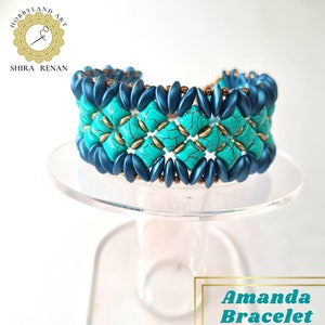 May include: A turquoise and blue beaded bracelet with a geometric pattern. The bracelet is on a white display stand. "Amanda Bracelet" is written in black text on a white background.