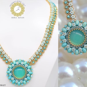 May include: A turquoise and white beaded necklace with a large turquoise pendant featuring a flower design. The necklace is made by Hobbyland Art Shira Renan and is called "Romantic Flower".