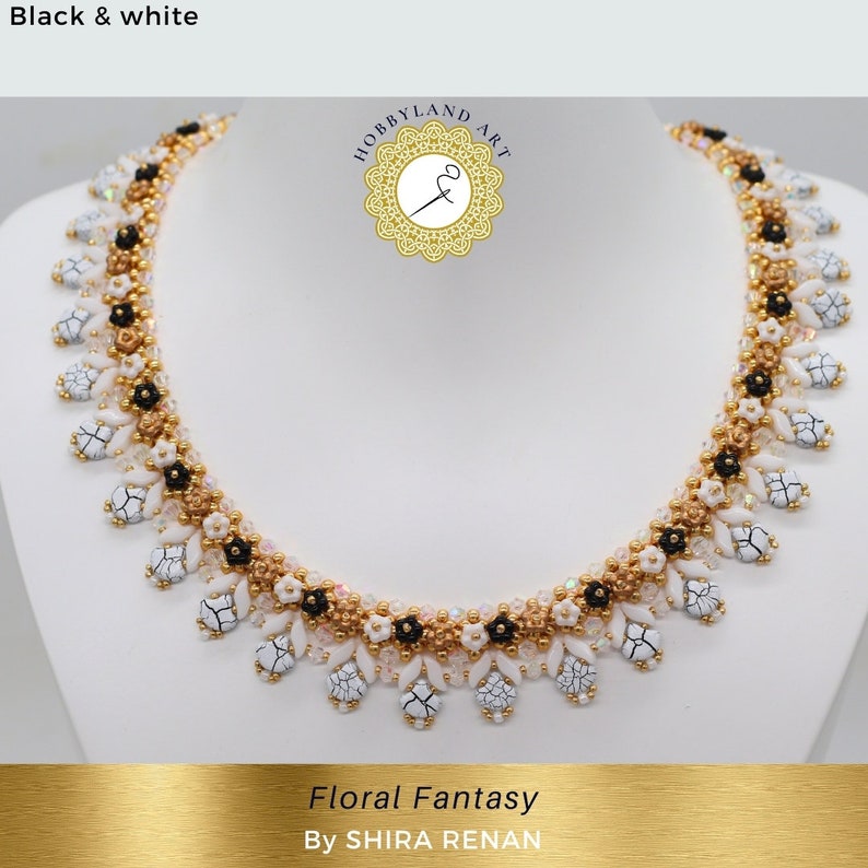 May include: A white, black, and gold beaded necklace with a floral design. The necklace is called "Floral Fantasy" by SHIRA RENAN.