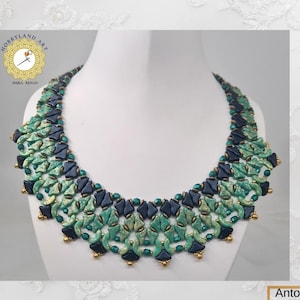 May include: A green and black beaded necklace with gold accents. The necklace is made of small, round beads and is arranged in a geometric pattern. The necklace is on a white background.