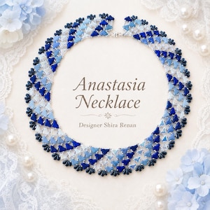 May include: A circular beaded necklace featuring a gradient of blue and white triangular beads arranged in a lattice pattern. The text in the center reads Anastasia Necklace, Designer Shira Renan. The piece is constructed with small metallic beads.