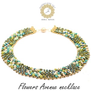 May include: A green, blue and white beaded necklace with a gold clasp. The necklace is made of small, round beads and has a floral design. The necklace is called "Flowers Avenue necklace".
