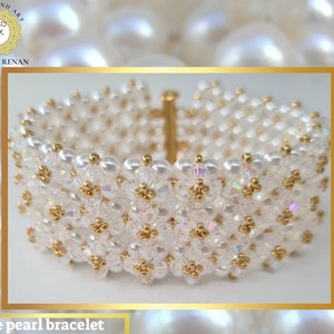 May include: A white pearl and gold bead bracelet with a delicate, intricate design. The bracelet is made with small, round pearls and gold beads, creating a beautiful and elegant look.