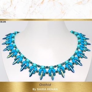 May include: A blue and turquoise beaded necklace with a graduated design. The necklace features a repeating pattern of small triangles and teardrop-shaped beads. The necklace is labeled "Orchid" and "By SHIRA RENAN".