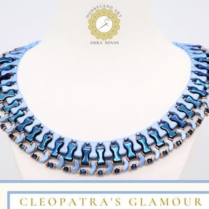 Op de afbeelding: Een blauwe en turquoise kralenketting met een kleurverloop-effect. De ketting is gemaakt van kleine, vierkante kralen en is gerangschikt in een patroon van afwisselende rijen. De ketting heet "Cleopatra's Glamour".