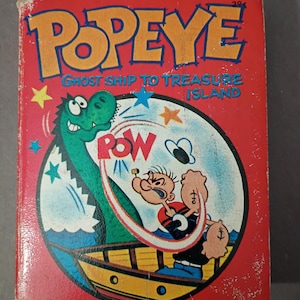 May include: Vintage Popeye comic book titled "Ghost Ship to Treasure Island." The cover is red with the word "POPEYE" in large orange letters. The comic features Popeye, a green dinosaur, and a boat. The comic book is slightly worn.
