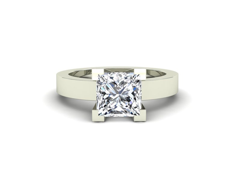 May include: A white gold engagement ring with a square-shaped diamond.