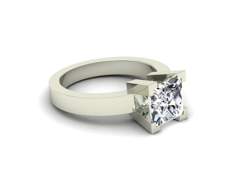 May include: A silver ring with a square-shaped diamond set in a prong setting.