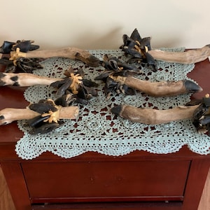 May include: Six handmade dog chew toys made from natural materials. Each toy is a deer leg with the hooves still attached and wrapped with leather.