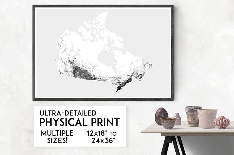 May include: A black and white print of a detailed map of Canada. The map is framed in a black frame and is hanging on a white wall. The text below the map reads "Ultra-Detailed Physical Print" and "Multiple Sizes! 12x18" to 24x36"