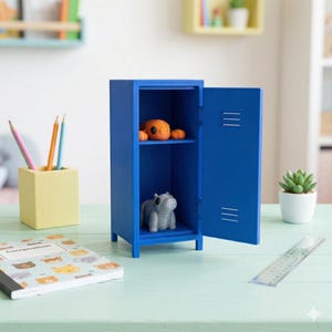 May include: A blue miniature locker with an open door, revealing a shelf with an orange clay figure and a grey hippo figurine. A yellow pencil holder with pencils, a notebook, and a ruler are on the table.