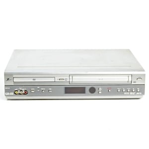 May include: A silver DVD and VHS player combo unit featuring a front-loading disc tray, a VHS cassette slot, a digital display screen, and various control buttons. The front panel includes yellow, white, and red RCA input ports and a USB port.