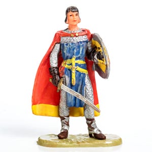May include: A toy knight figurine, standing on a small base. The knight wears a blue tunic, chainmail, and a red cape with yellow trim. He holds a sword and a shield with a yellow and black design.