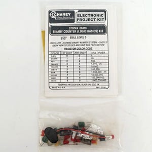 May include: A clear plastic bag containing an electronic project kit. The kit includes various small electronic components and a printed paper with the text "CHANEY Electronics ELECTRONIC PROJECT KIT BINARY COUNTER (LOGIC BASICS) KIT".
