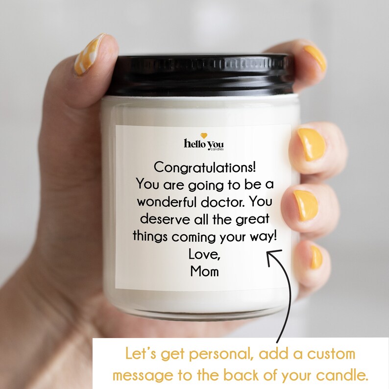 May include: A white candle with a black lid and a label that reads "Congratulations! You are going to be a wonderful doctor. You deserve all the great things coming your way! Love, Mom".