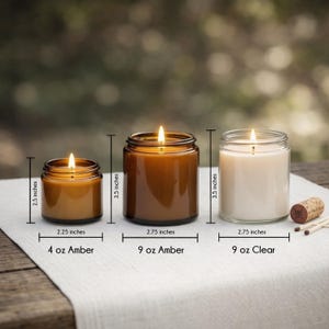 three candles of different sizes, with a cork stopper, placed on a wooden surface. The candles are labeled with their respective sizes in inches.