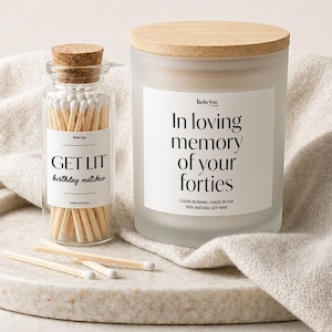 a candle and a matchbox holder, both with a label that reads "In loving memory of your forties".