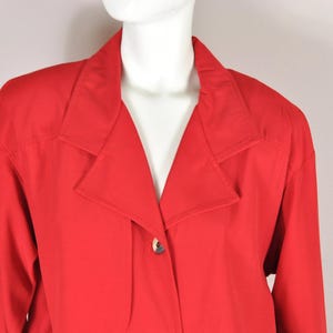 May include: A red blazer with a large collar and a single button closure.