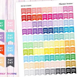 May include: A sheet of colorful stickers with the text "PAY DAY" in white lettering on each sticker. The stickers are arranged in a grid pattern and are in various colors, including red, orange, yellow, green, blue, purple, and pink.