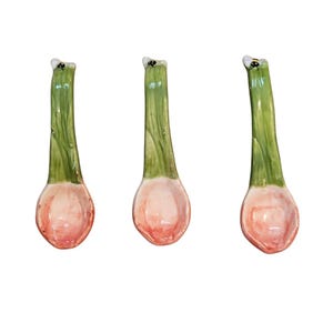 May include: Set of three ceramic spoons with a green and pink floral design and a small black bee on the handle.