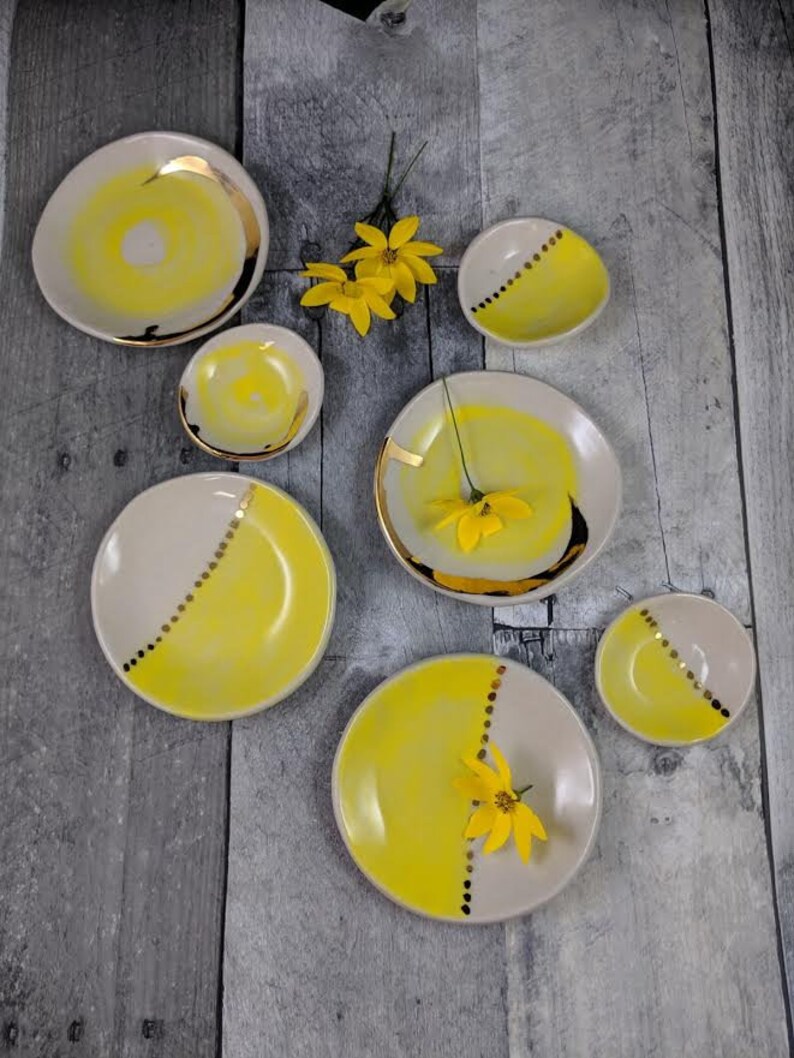 small jewelry dish with bright yellow design and 22k gold embellishments